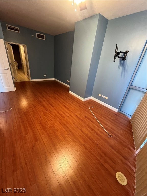 Empty room featuring wood finished floors and baseboards