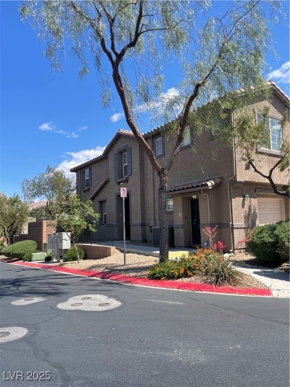 View of front of house featuring stucco siding and