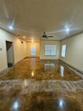 Unfurnished living room with a ceiling fan