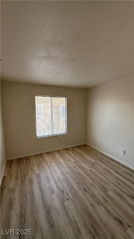 Spare room with wood finished floors and a texture