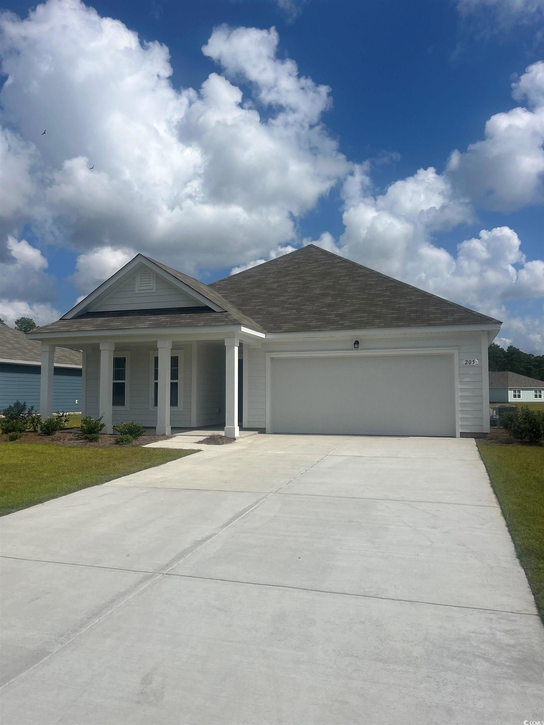 View of front facade featuring a garage and covere
