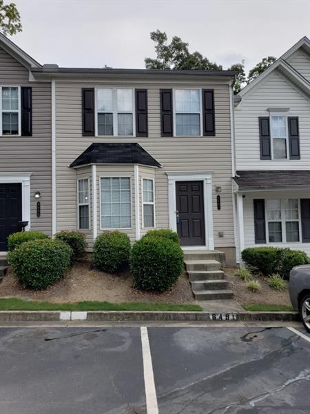 Front of Home with 1 assigned parking and unassigned guest parking