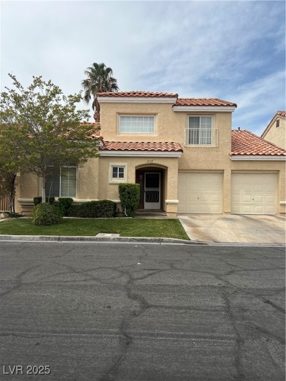 Mediterranean / spanish home with a tile roof, a g