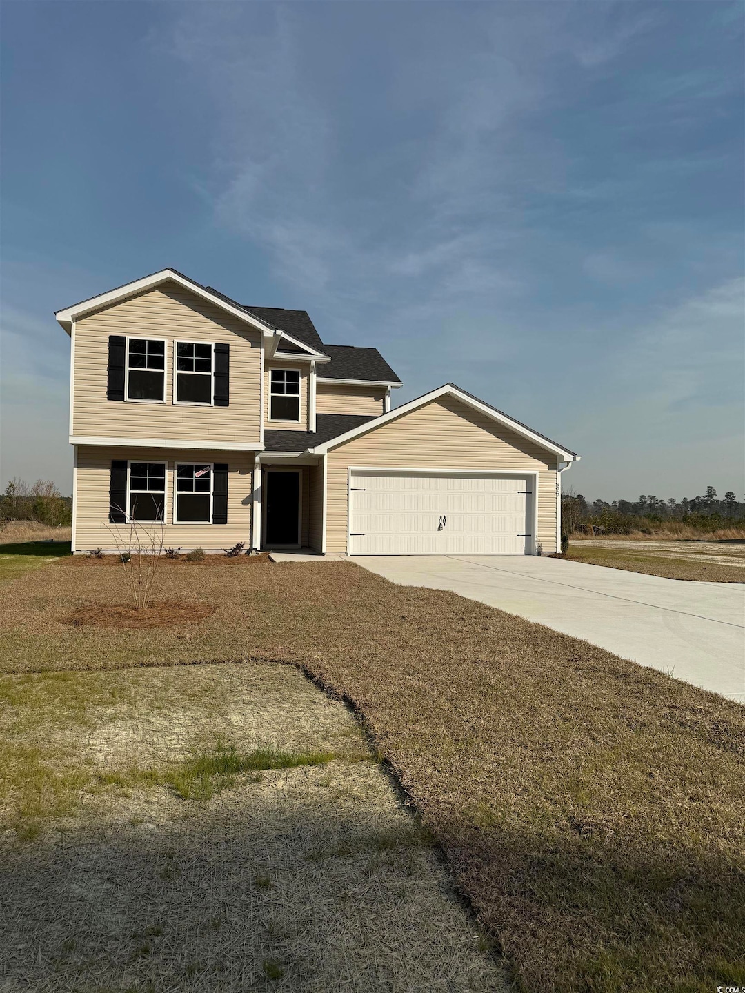 View of front facade featuring a garage and concre