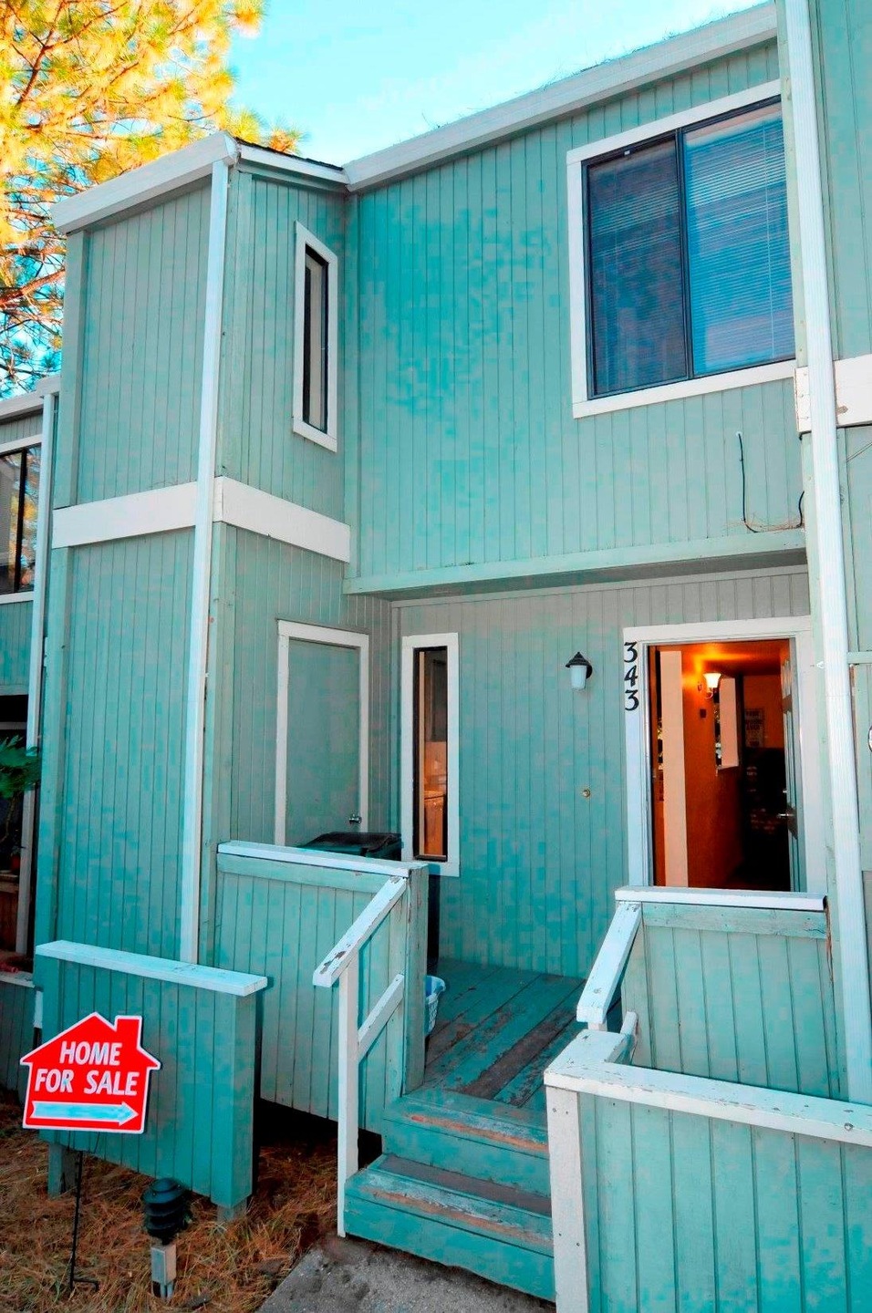 Front of home.  Set back from the street, with a little front porch and 2 storage closets.