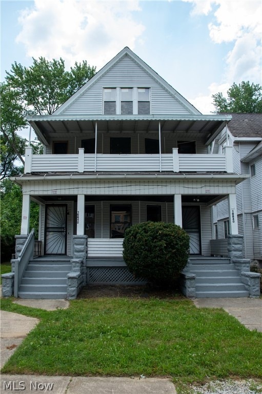 View of front of house with a porch and a balcony