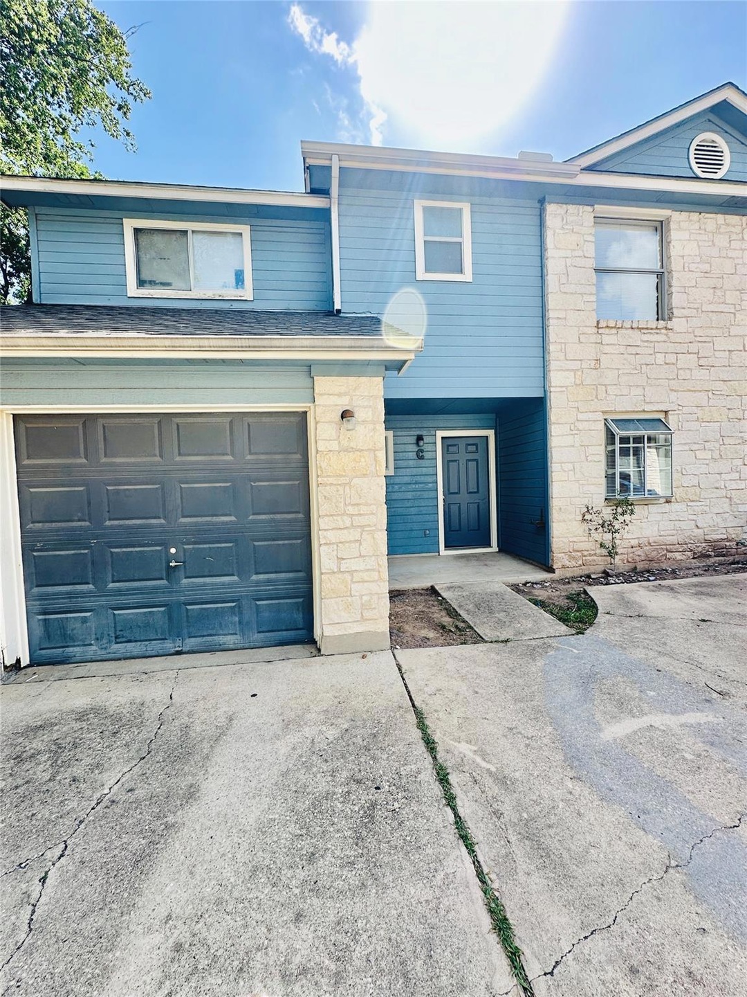 Multi unit property featuring concrete driveway a
