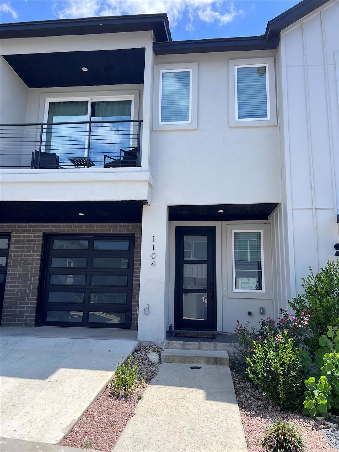 View of exterior entry featuring a balcony, board