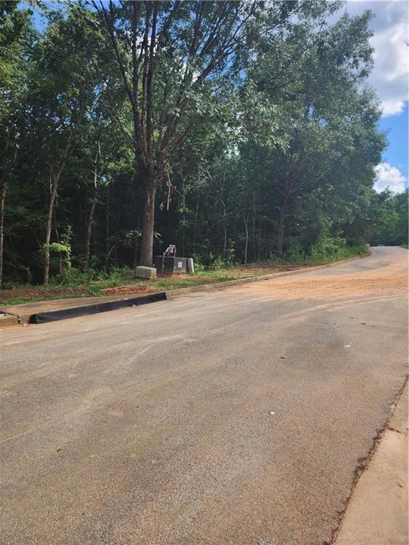 View of asphalt road with curbs