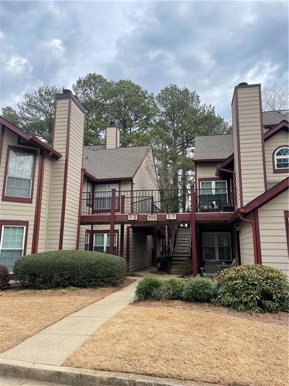 View of front of house featuring stairs, a shingle