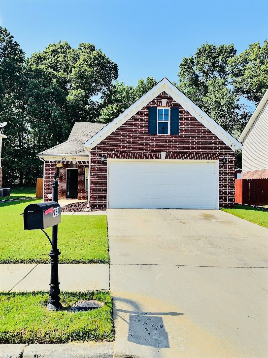 View of front of home with a garage and a front ya