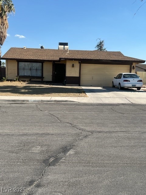 Ranch-style home with an attached garage and driveway