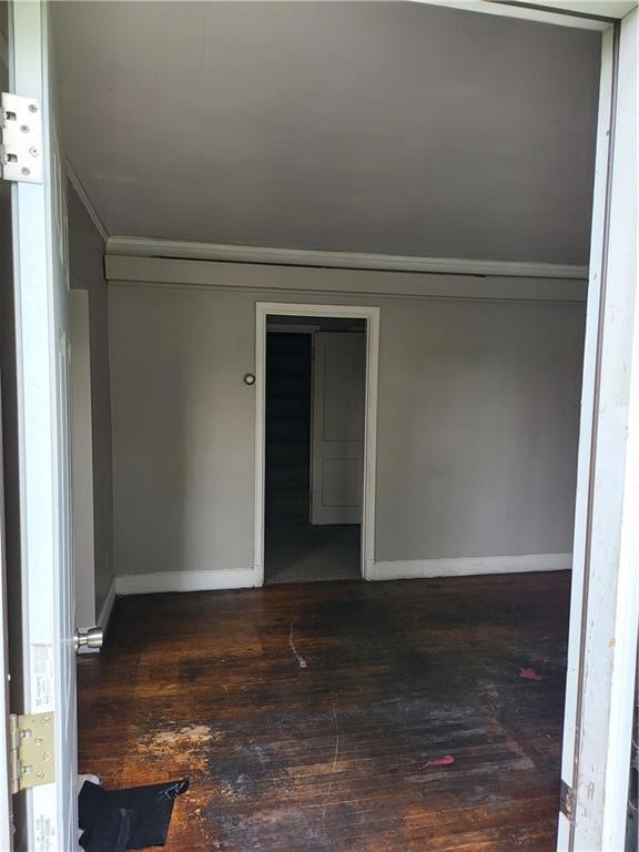 Empty room featuring dark hardwood / wood-style fl
