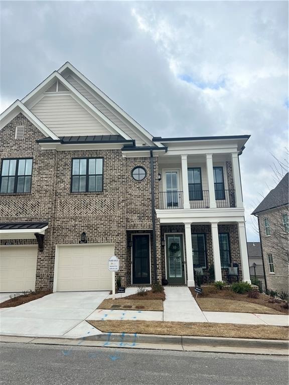 Townhome / multi-family property with a balcony an
