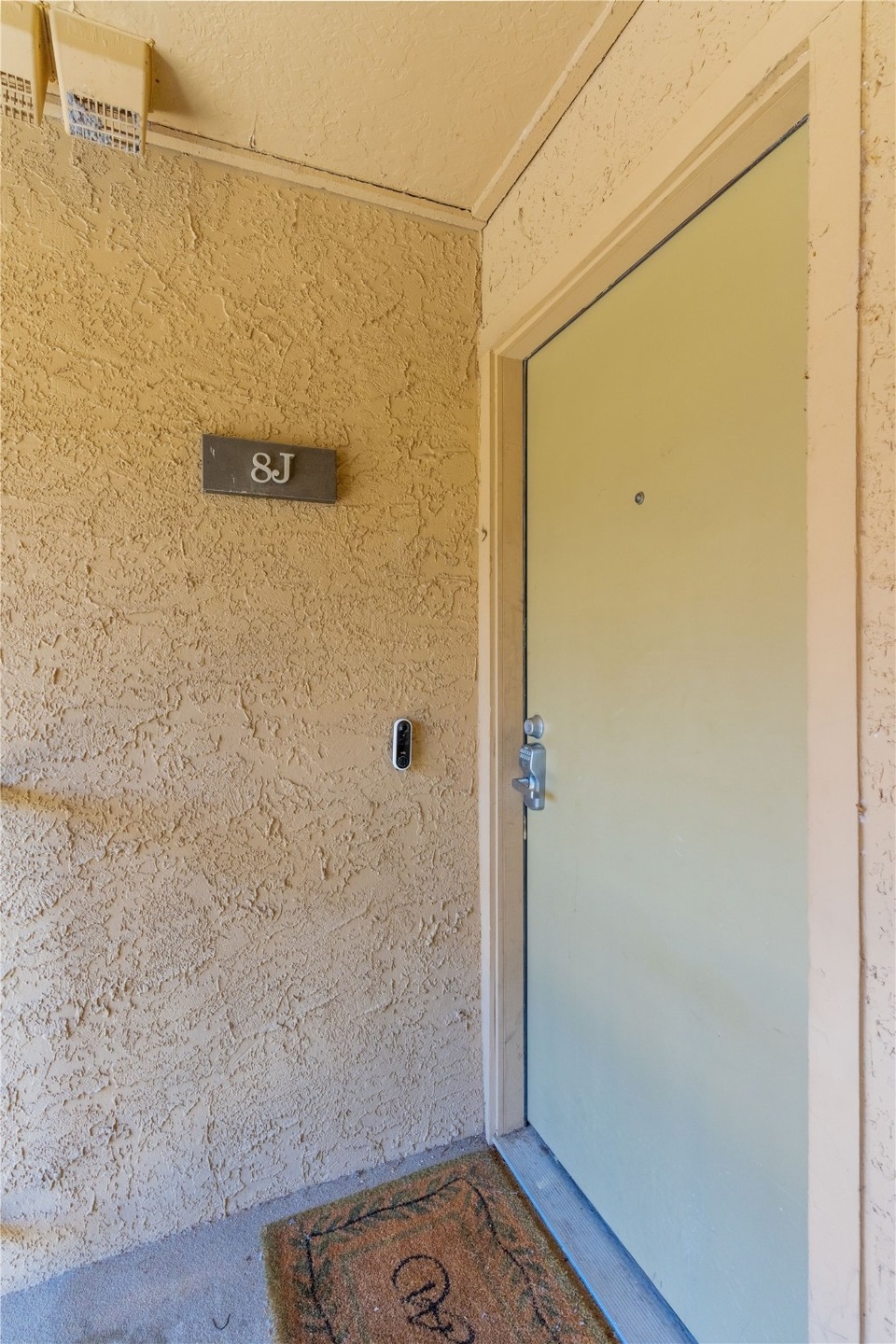 Doorway to property with stucco siding