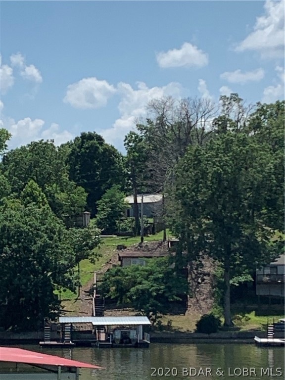 VIEW OF HOUSE AND DOCK FROM ACROSS THE COVE