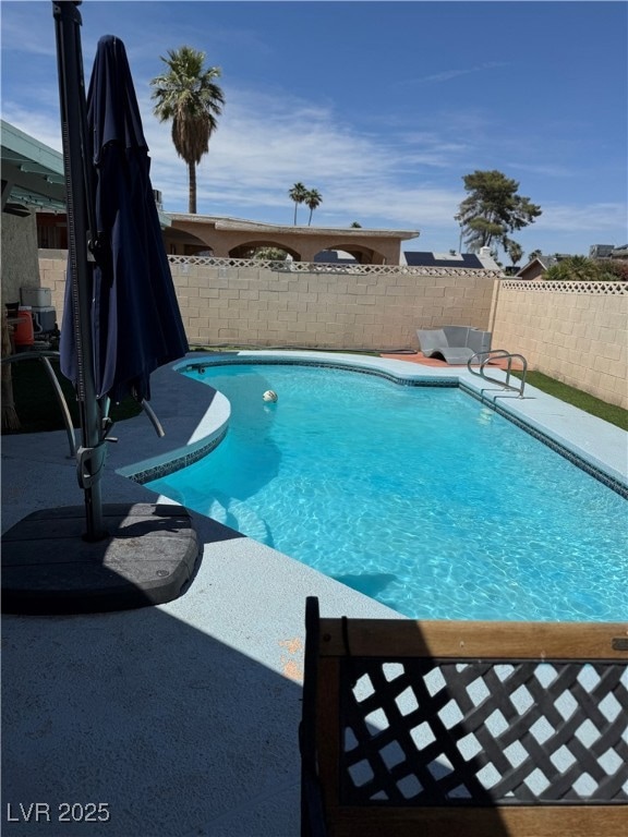 View of pool with a fenced backyard