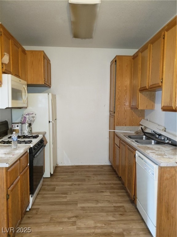 Kitchen with dishwasher, stove, light countertops,