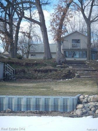 VIEW OF HOME AND SEAWALL