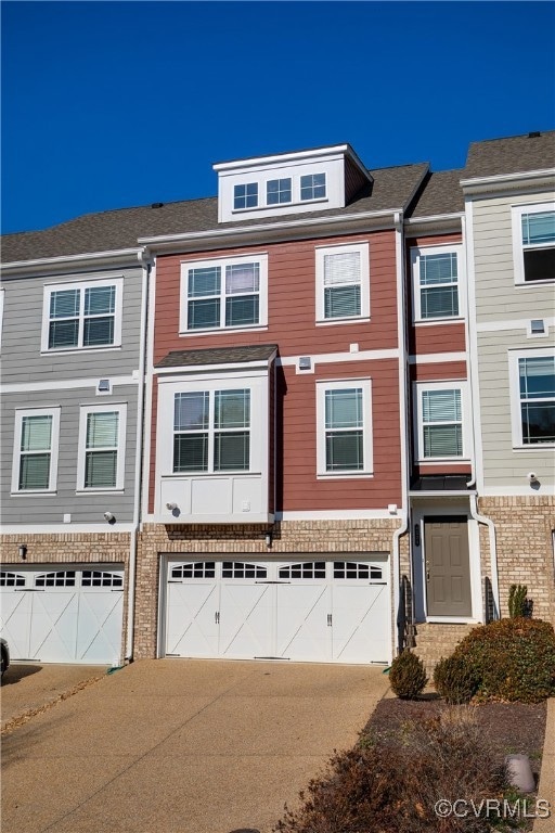 Townhome / multi-family property with a garage