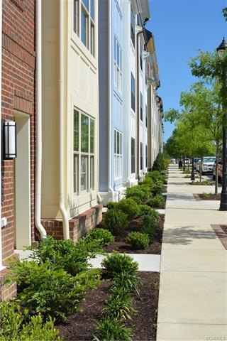 Image is a visual representation of a condominium building exterior. This home is not yet built.