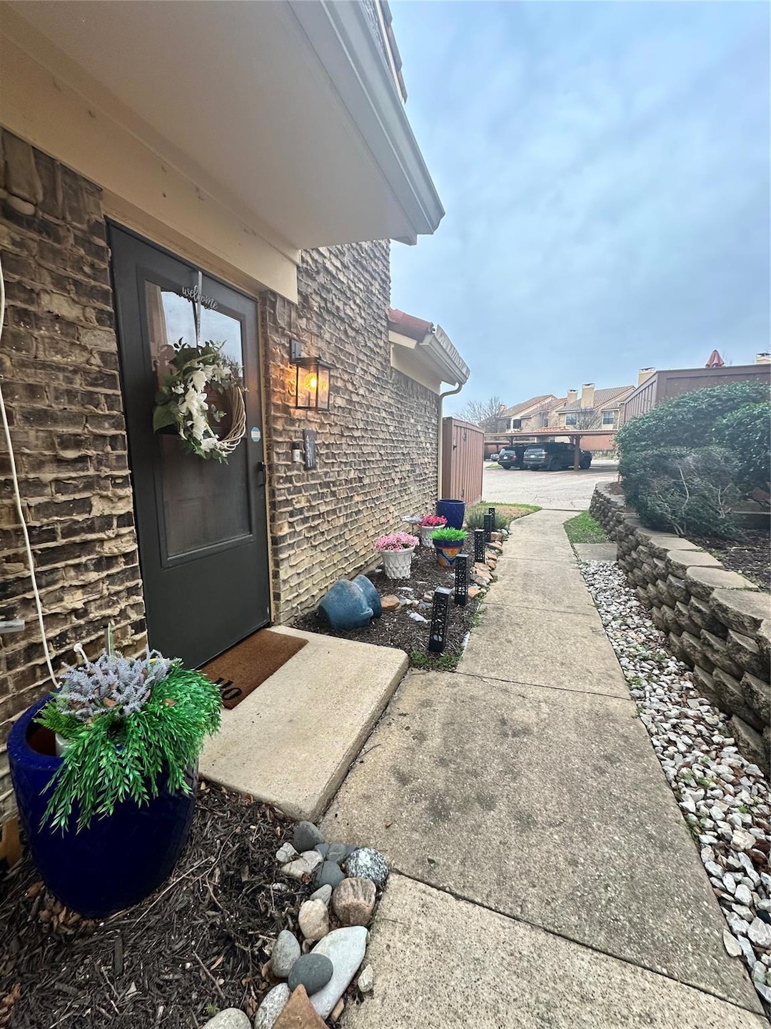View of exterior entry with brick siding