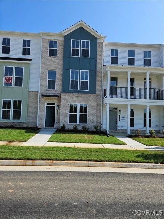 View of front of house with brick siding and a fro
