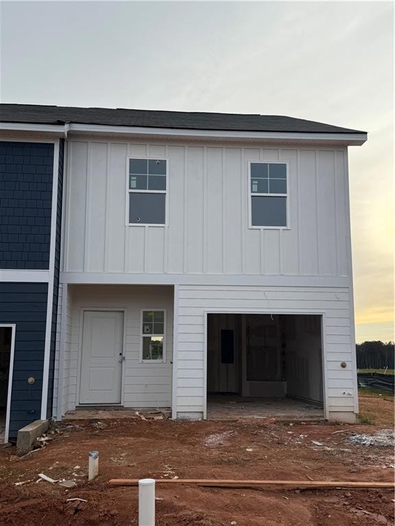 View of front of house with board and batten sidin