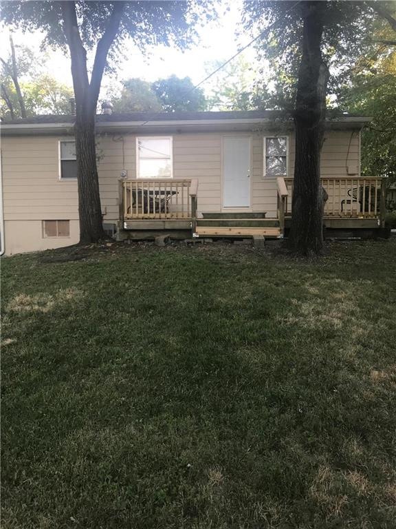 Deck is covered by two large shade trees.