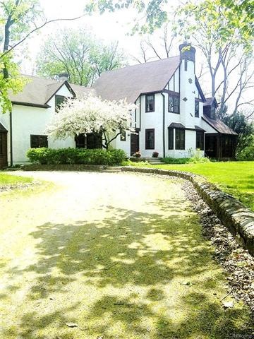 Classic Tudor with welcoming circle drive.