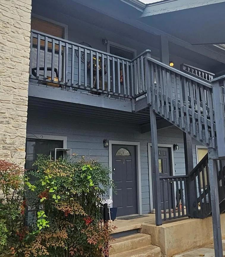 View of exterior entry featuring a balcony