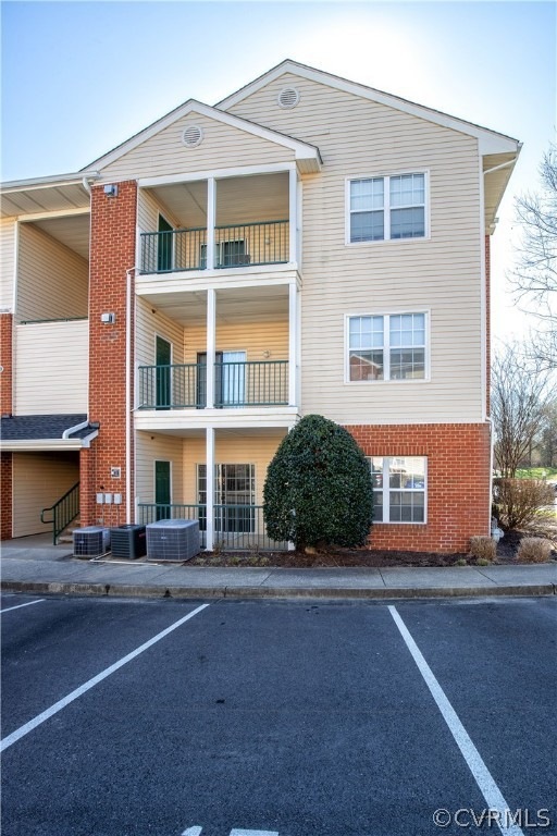 View of building exterior with central AC unit