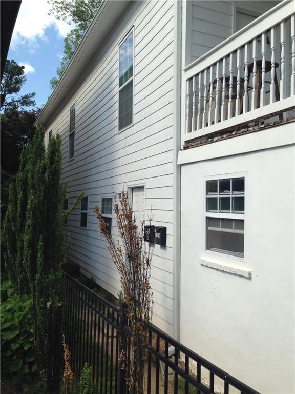 View of property exterior featuring a balcony