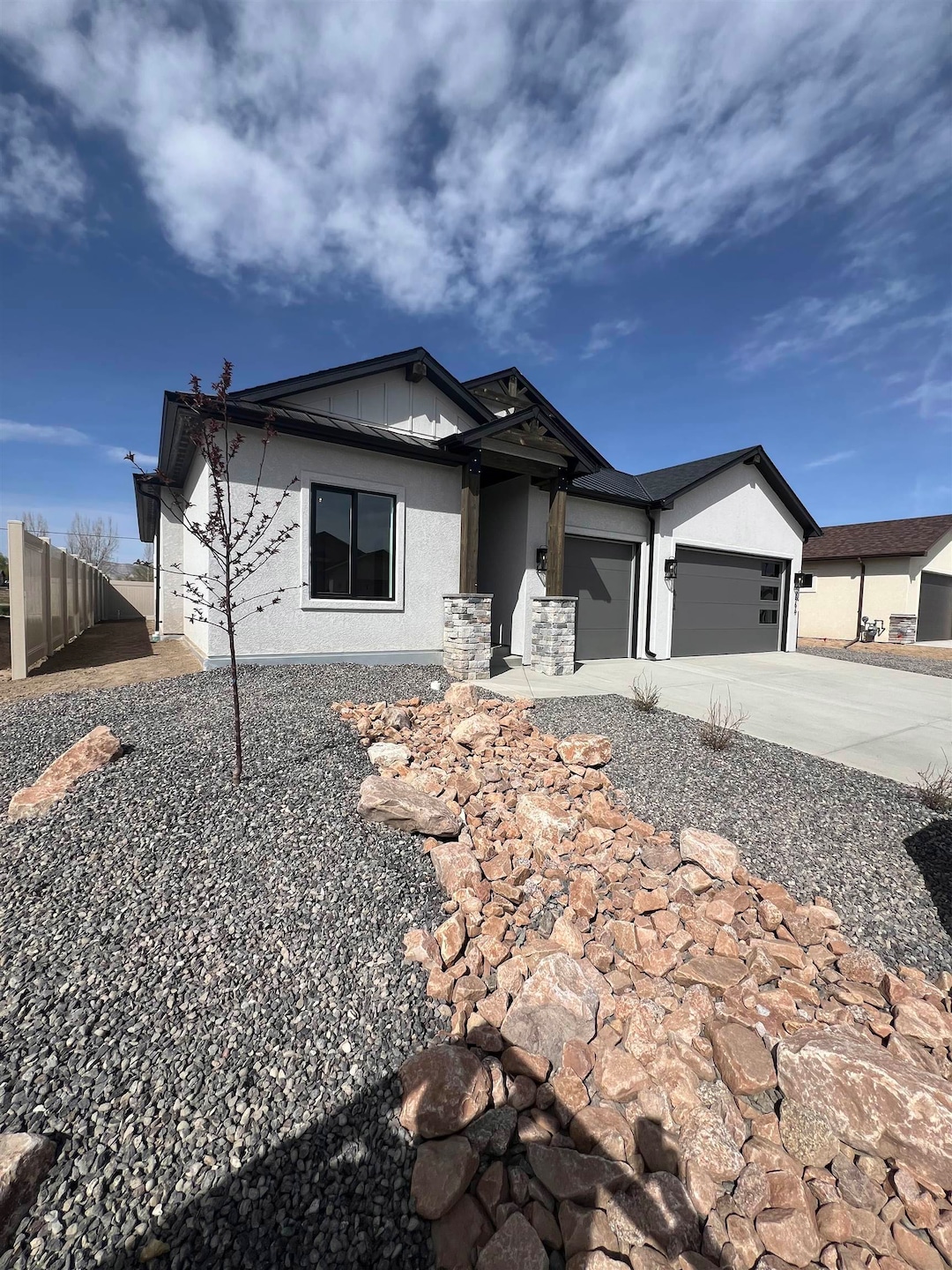 Now includes front landscaping including an ornamental tree and several bright bushes