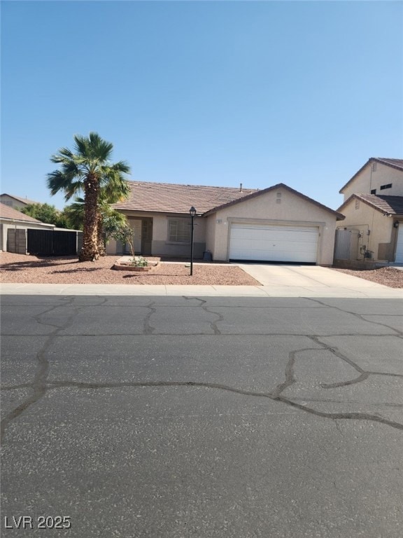 Ranch-style home with driveway, an attached garage