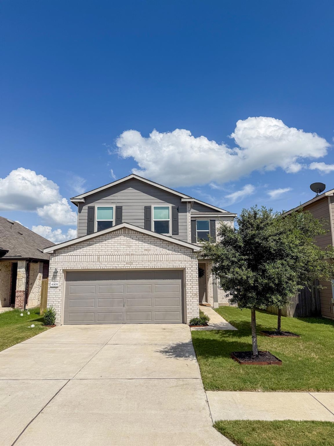 Traditional-style house featuring concrete drivew