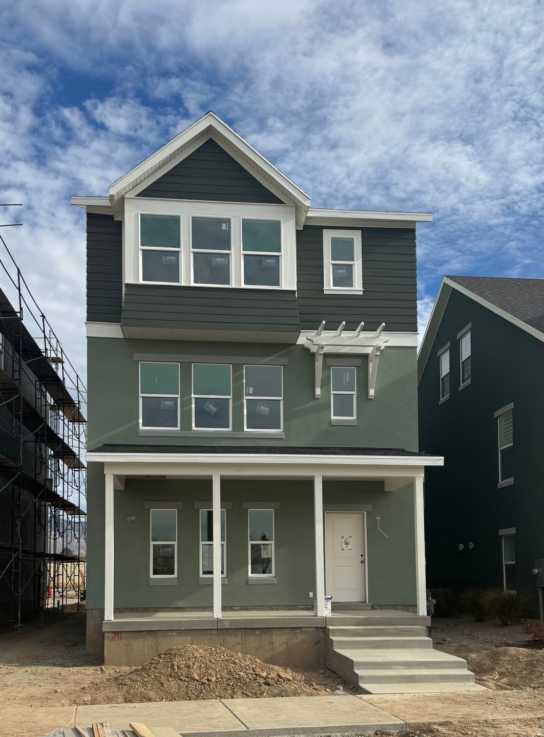View of front of home with a porch and stucco siding