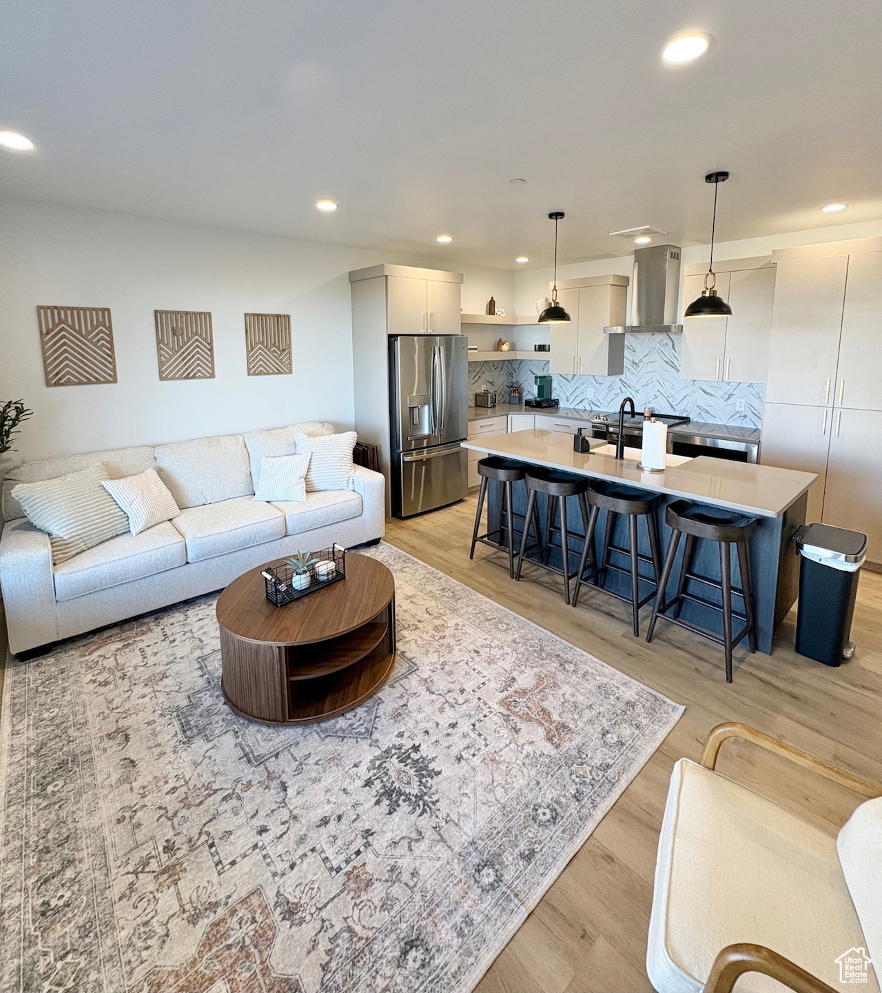 Living area with recessed lighting and light wood-type flooring