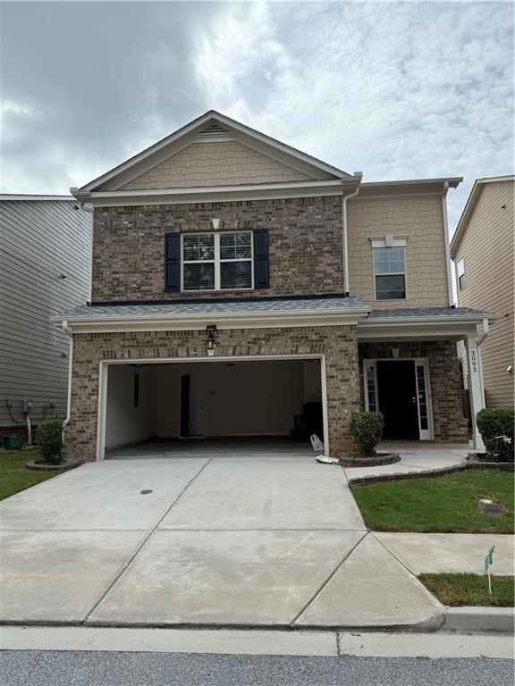 View of front of home featuring a garage and central AC