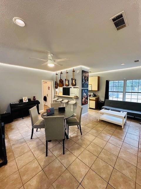 Dining space featuring light tile patterned floor