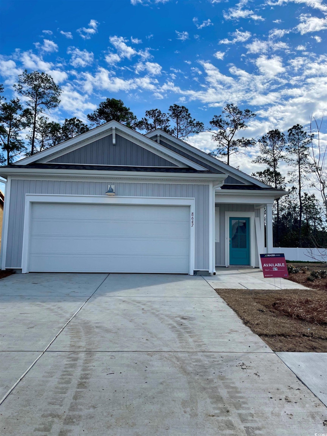 View of front of property with a garage, concrete 