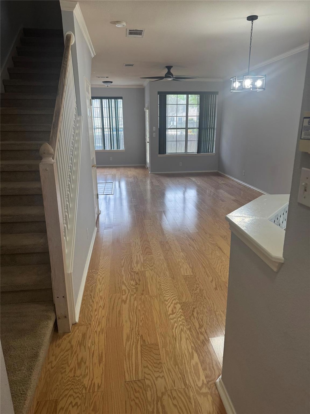 Hall featuring crown molding, light wood-style fl