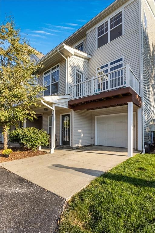 View of front of house with garage and a deck
