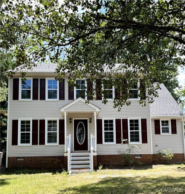 Colonial inspired home with a front yard