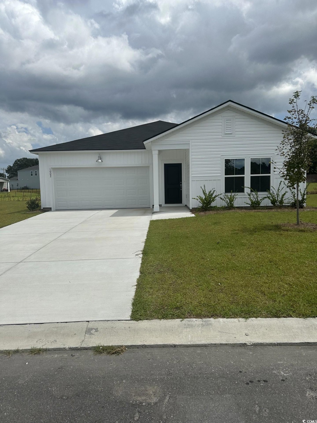 View of front facade featuring a garage and a fron