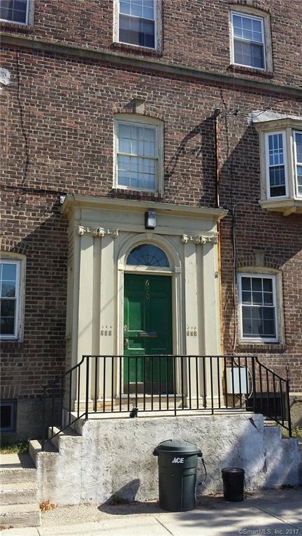 Entry door showing 2nd floor bay window of unit