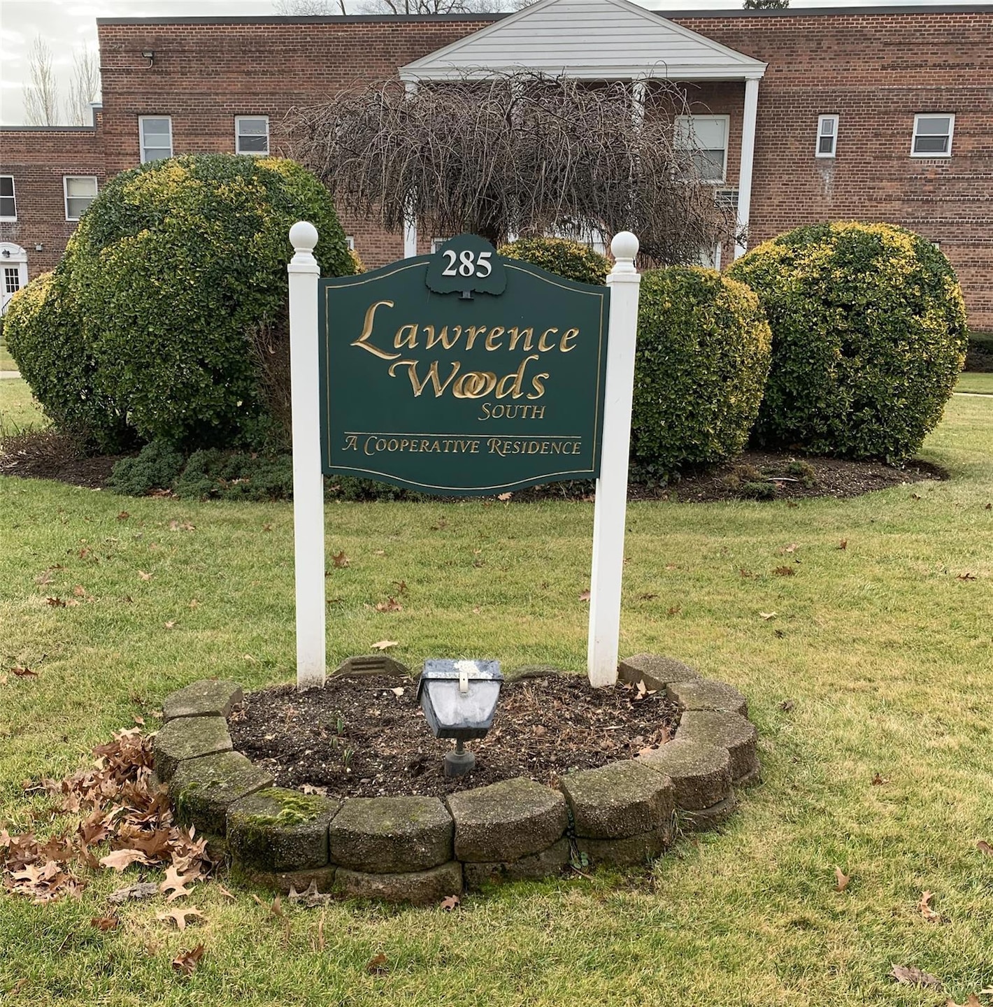 Community / neighborhood sign with a yard