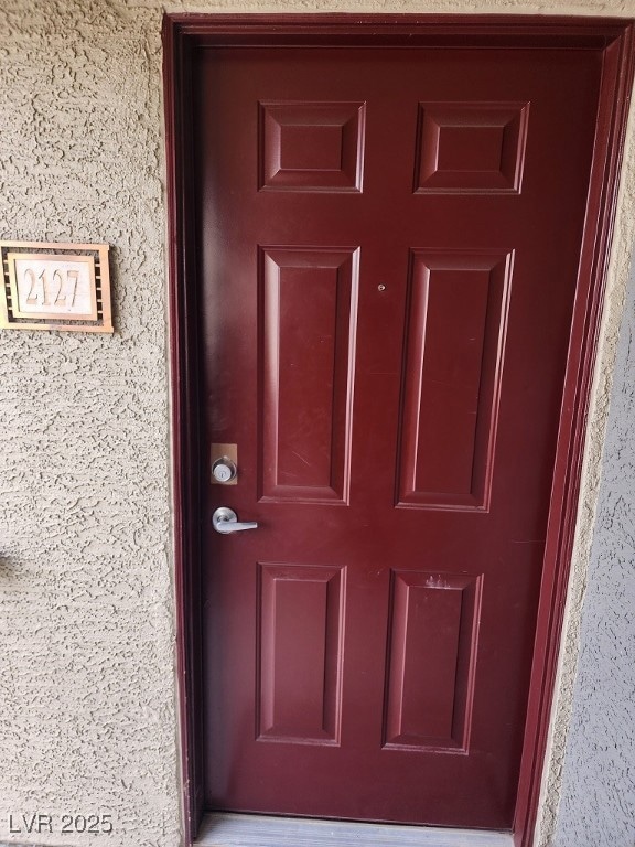 Property entrance with stucco siding