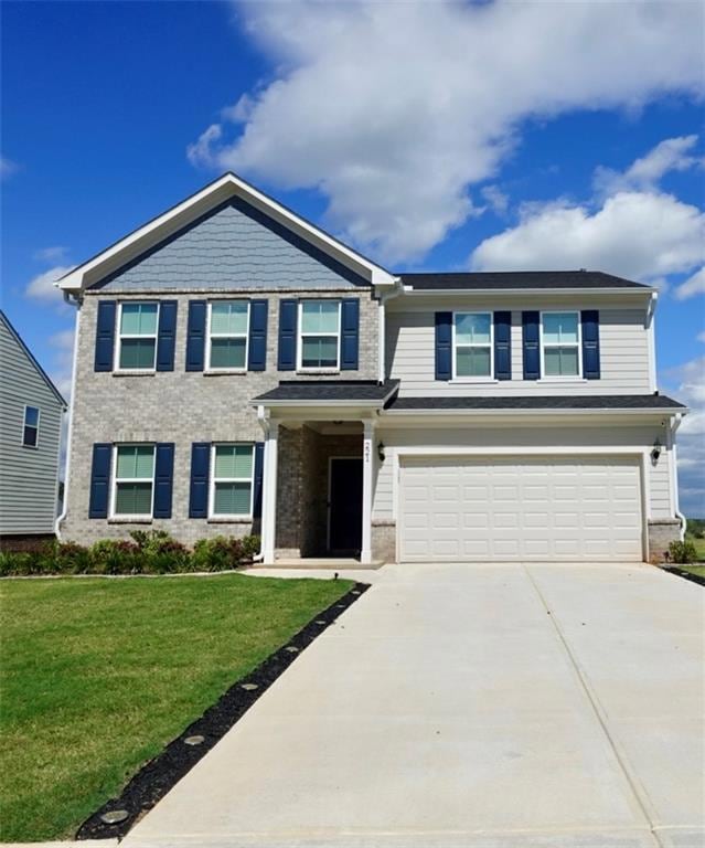 Craftsman-style home featuring brick siding, drive