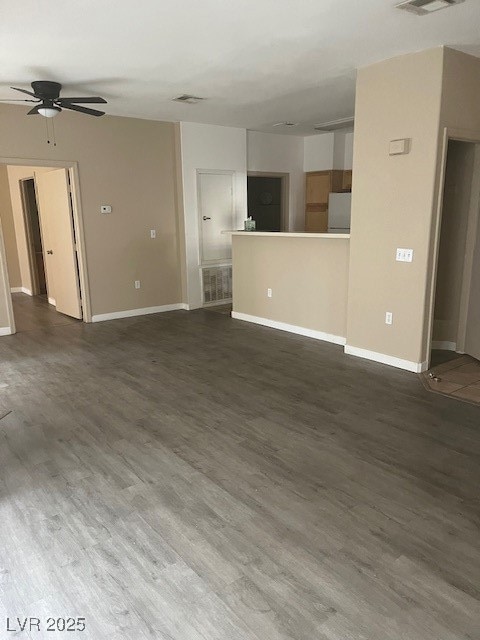 Unfurnished living room featuring dark wood-style